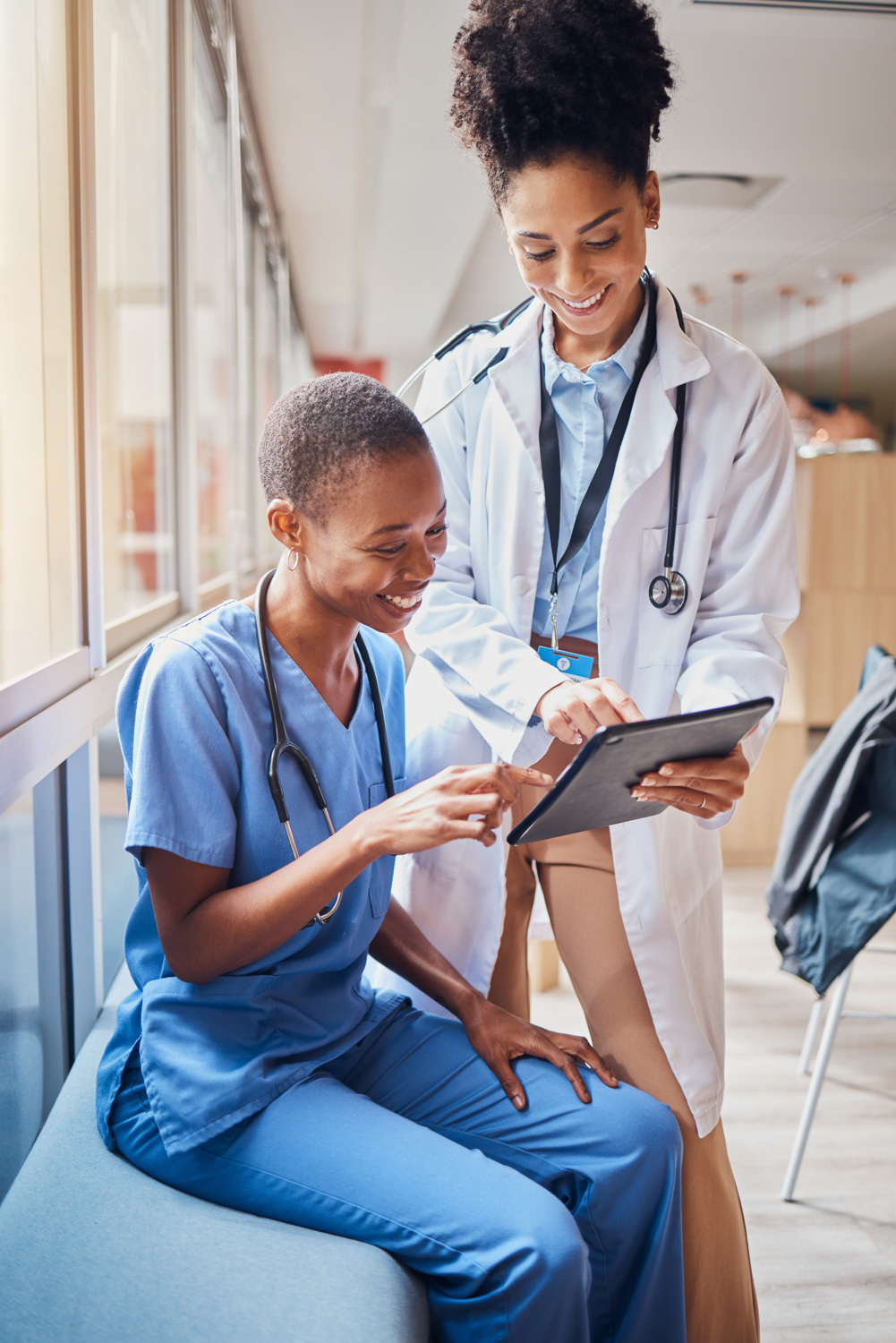female doctor and female nurse reviewing document