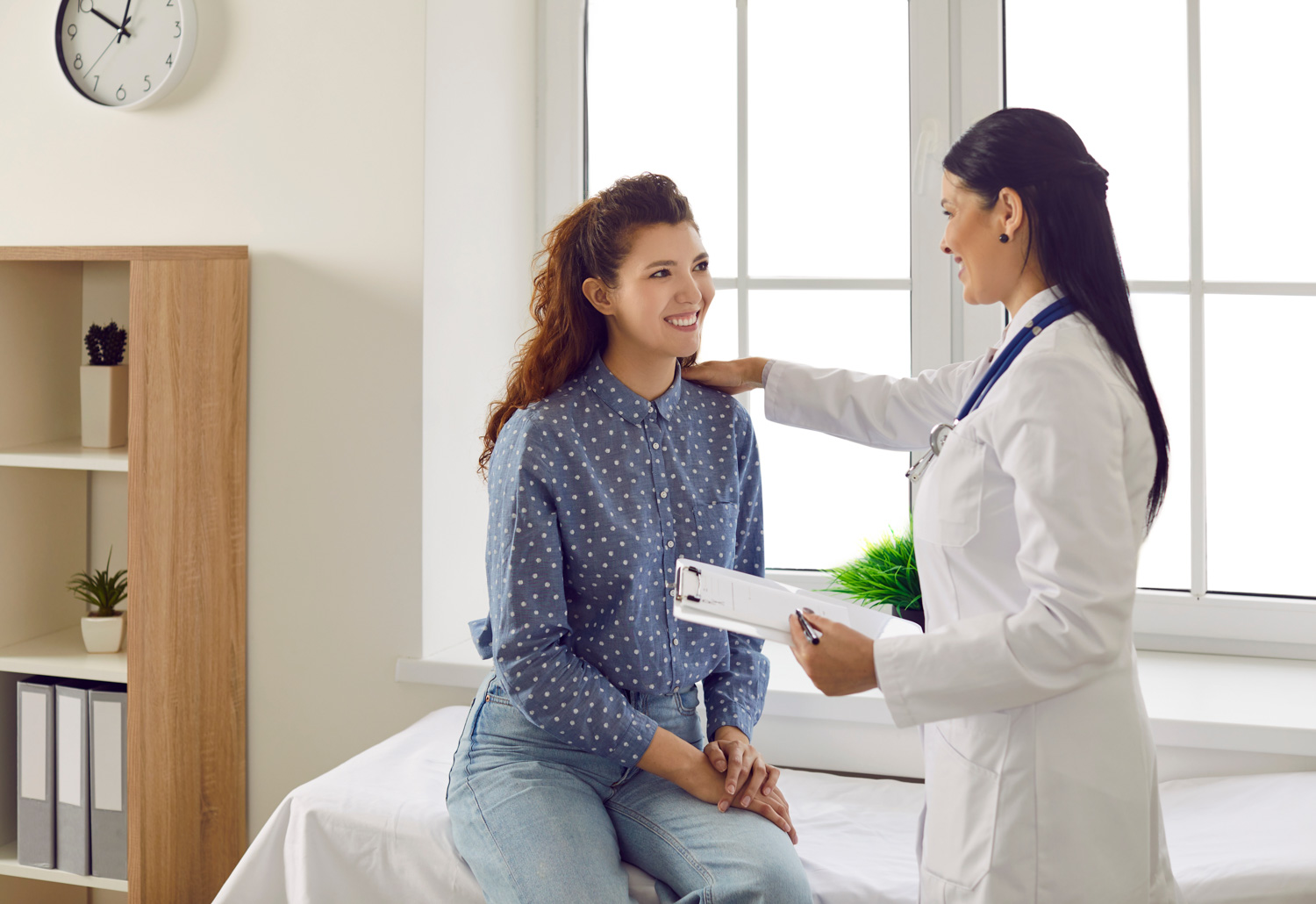 female doctor consulting with female patient