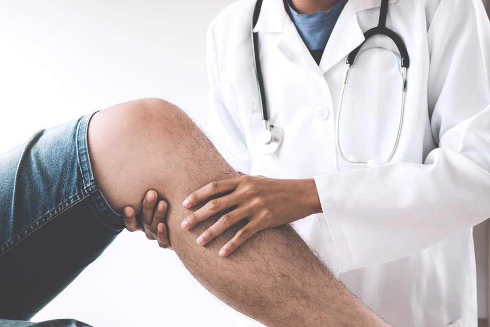 orthopedist examining knee