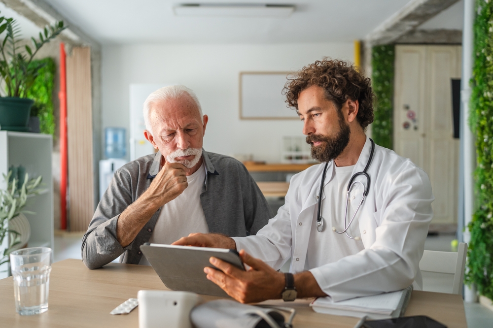 Elderly patient consulting with doctor