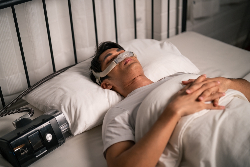 man sleeping using a CPAP apparatus