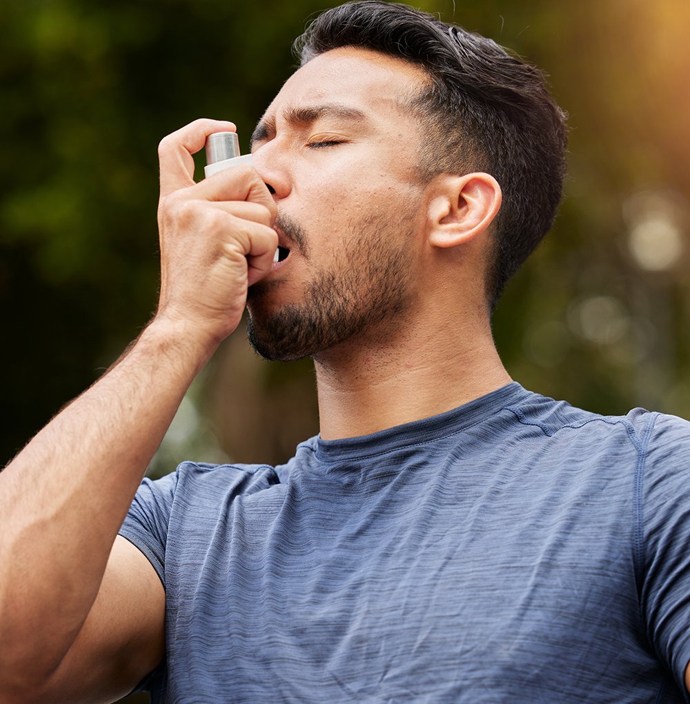 Man Using Inhaler On Walk