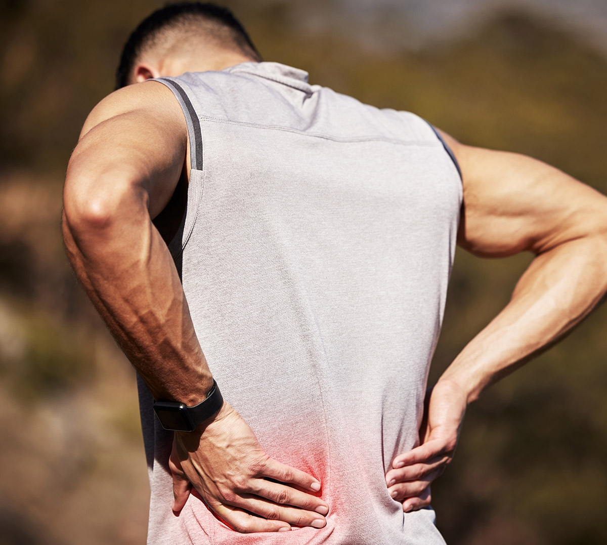 Athletic Younger Man with Lower Back Pain