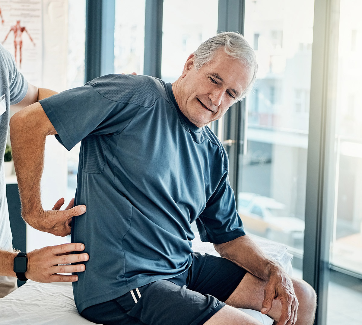 Doctor with Elderly Man Back Pain