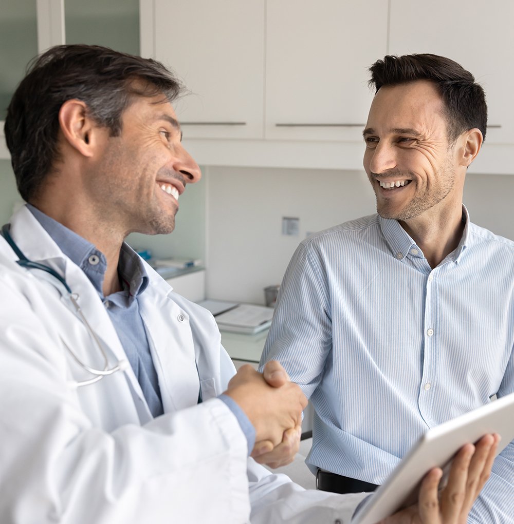Doctor greeting a new adult patient with a handshake — Townsen Physician Group, Houston
