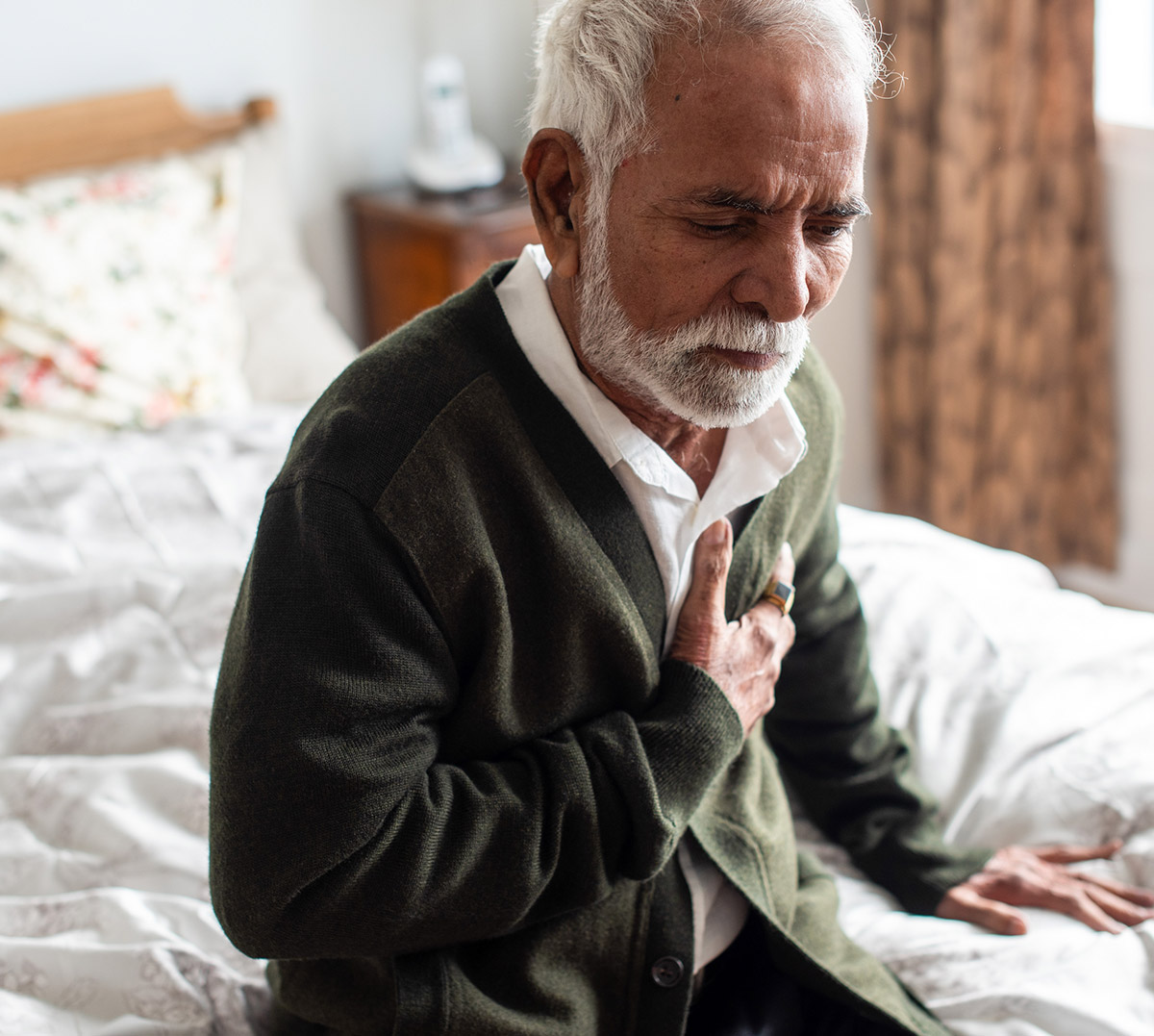 Elderly Man on Bed Chest Pain