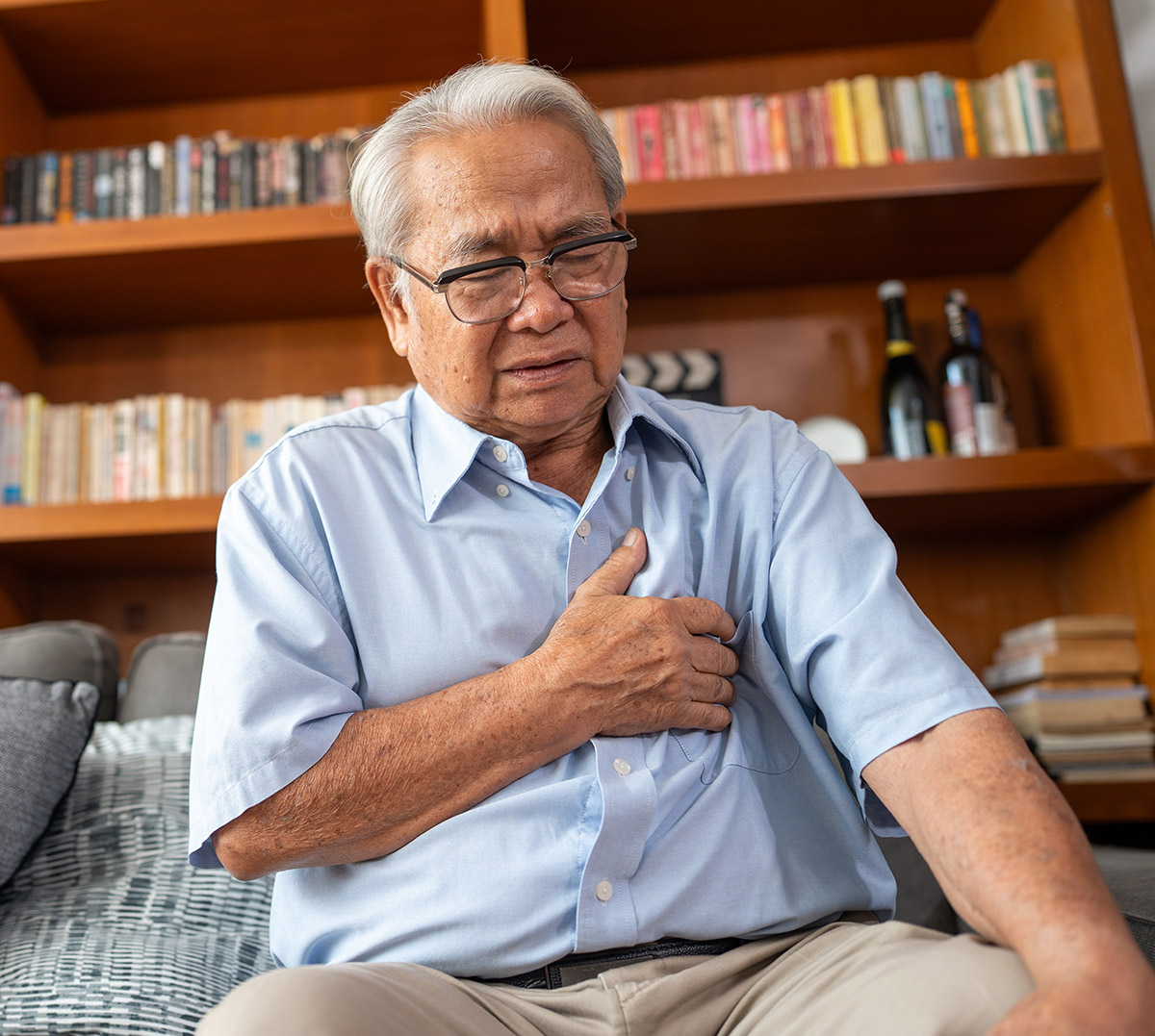 Elderly Man Holding Chest Area