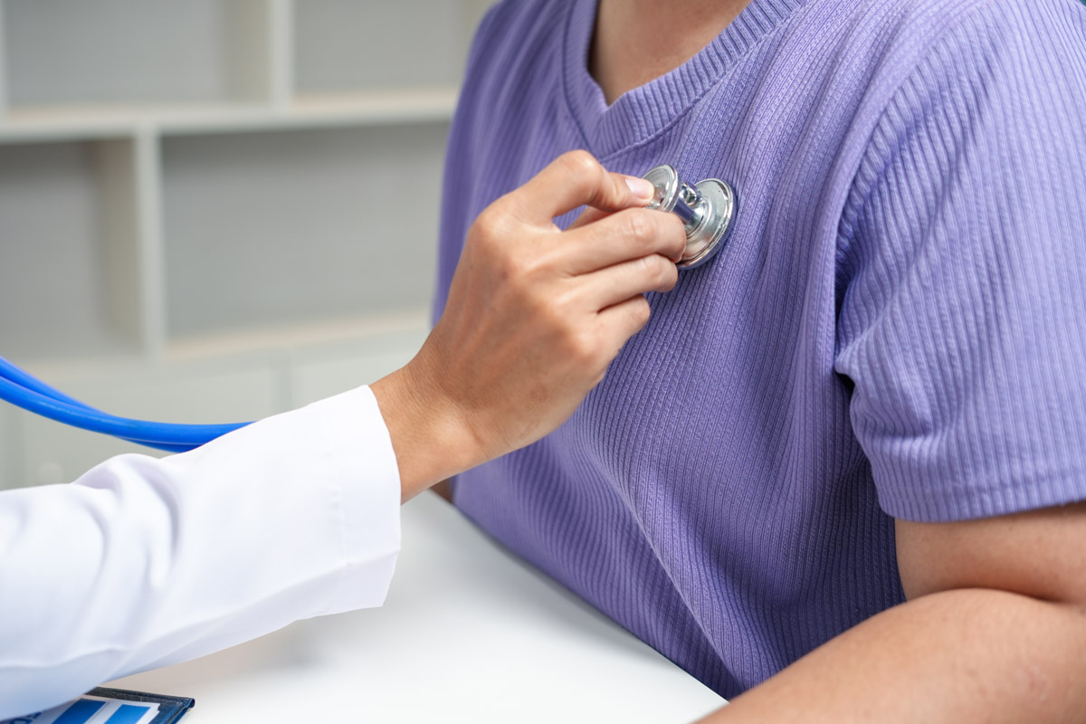 Doctor checking a male patient's heartbeat at Townsen Physician Group in Houston