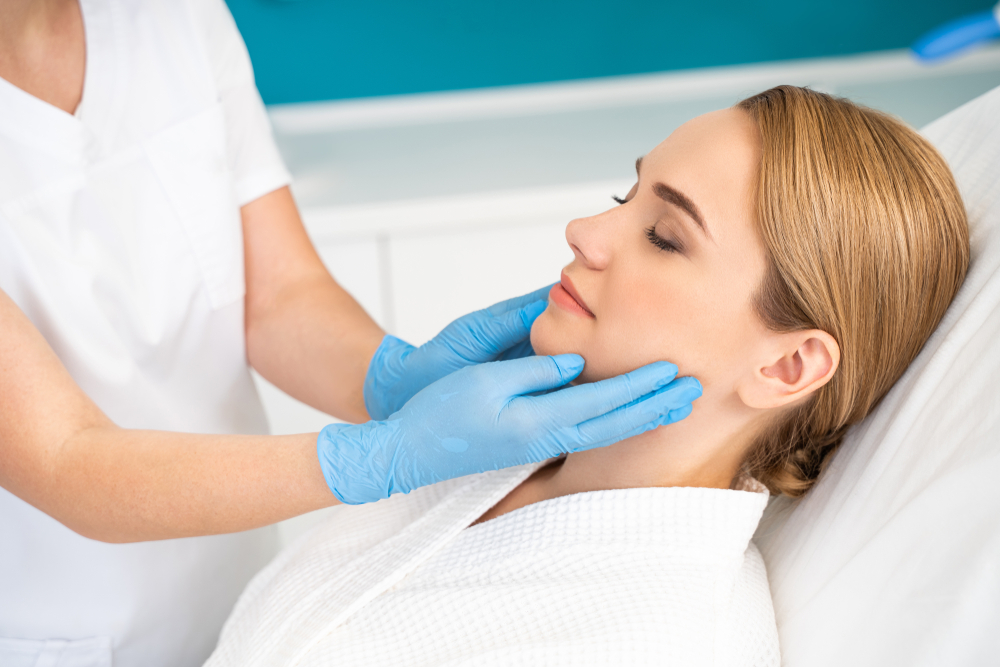 female nurse listening to elderly woman's heartbeat