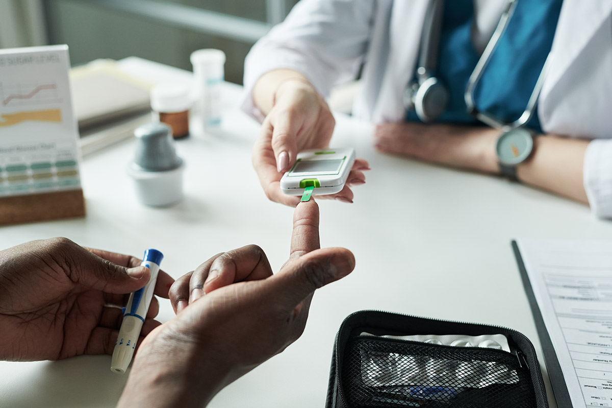 Female doctor checking a patient's blood levels at Townsen Physician Group in Houston