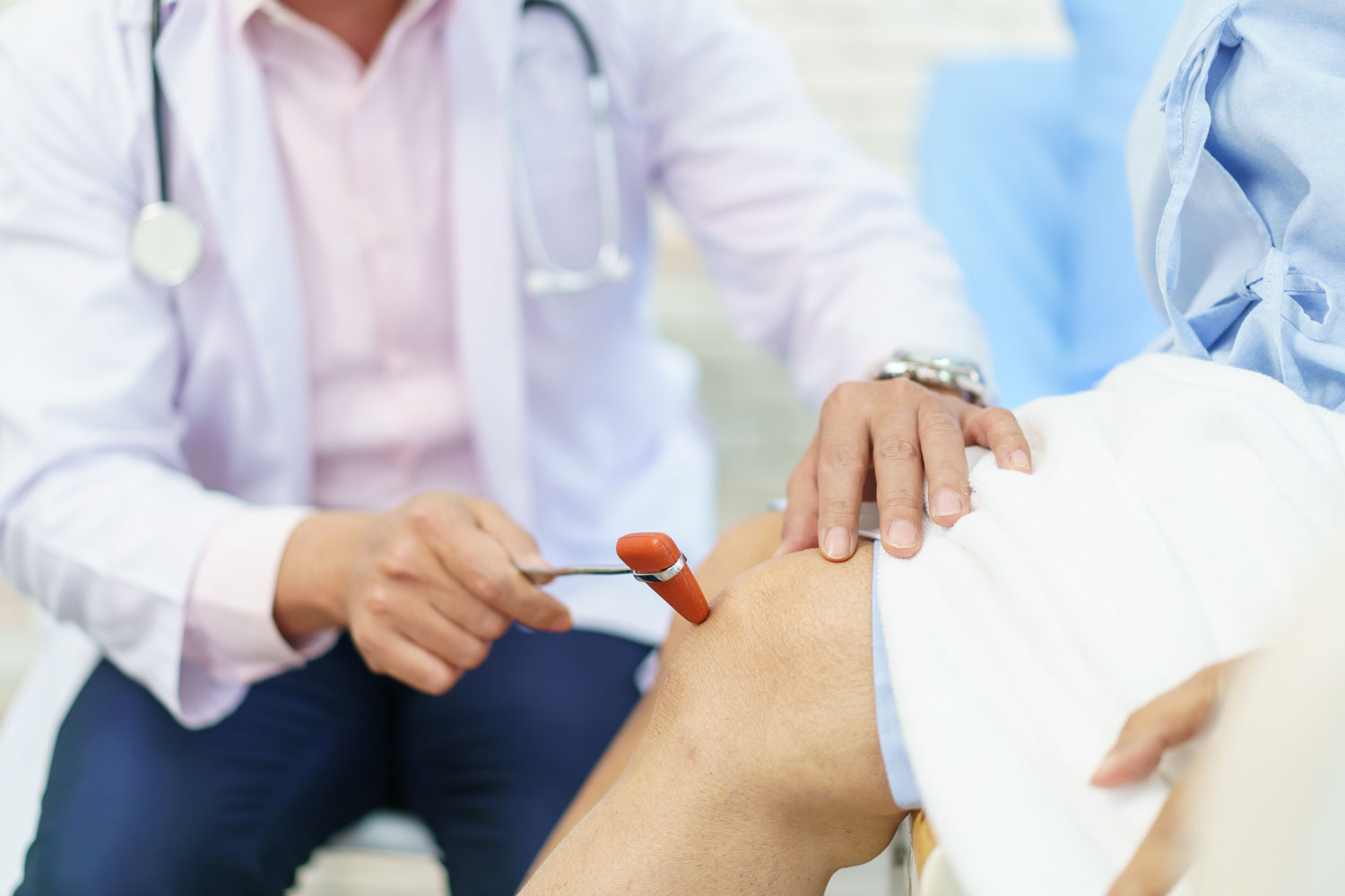 Doctor evaluating patient's knee