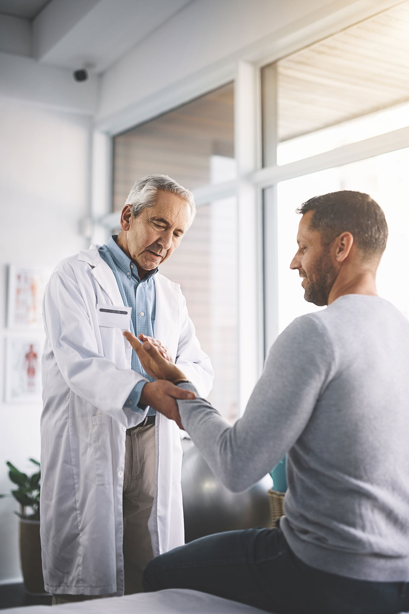 Doctor Diagnosing Patient's Wrist