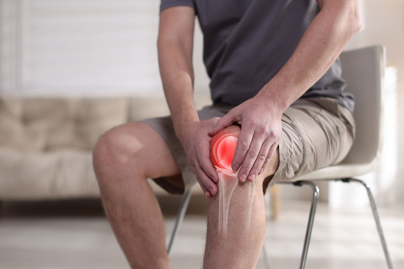 Man on chair with knee pain