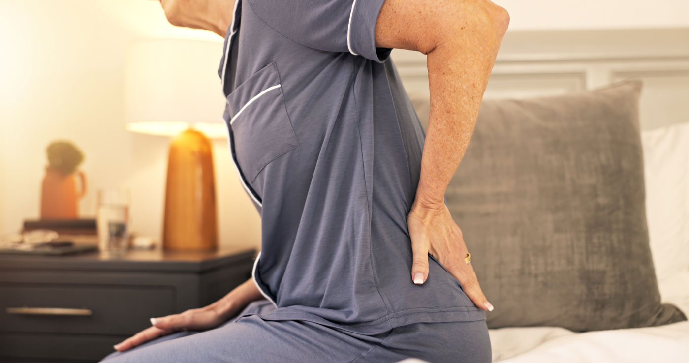 Woman in Bed with Back Pain