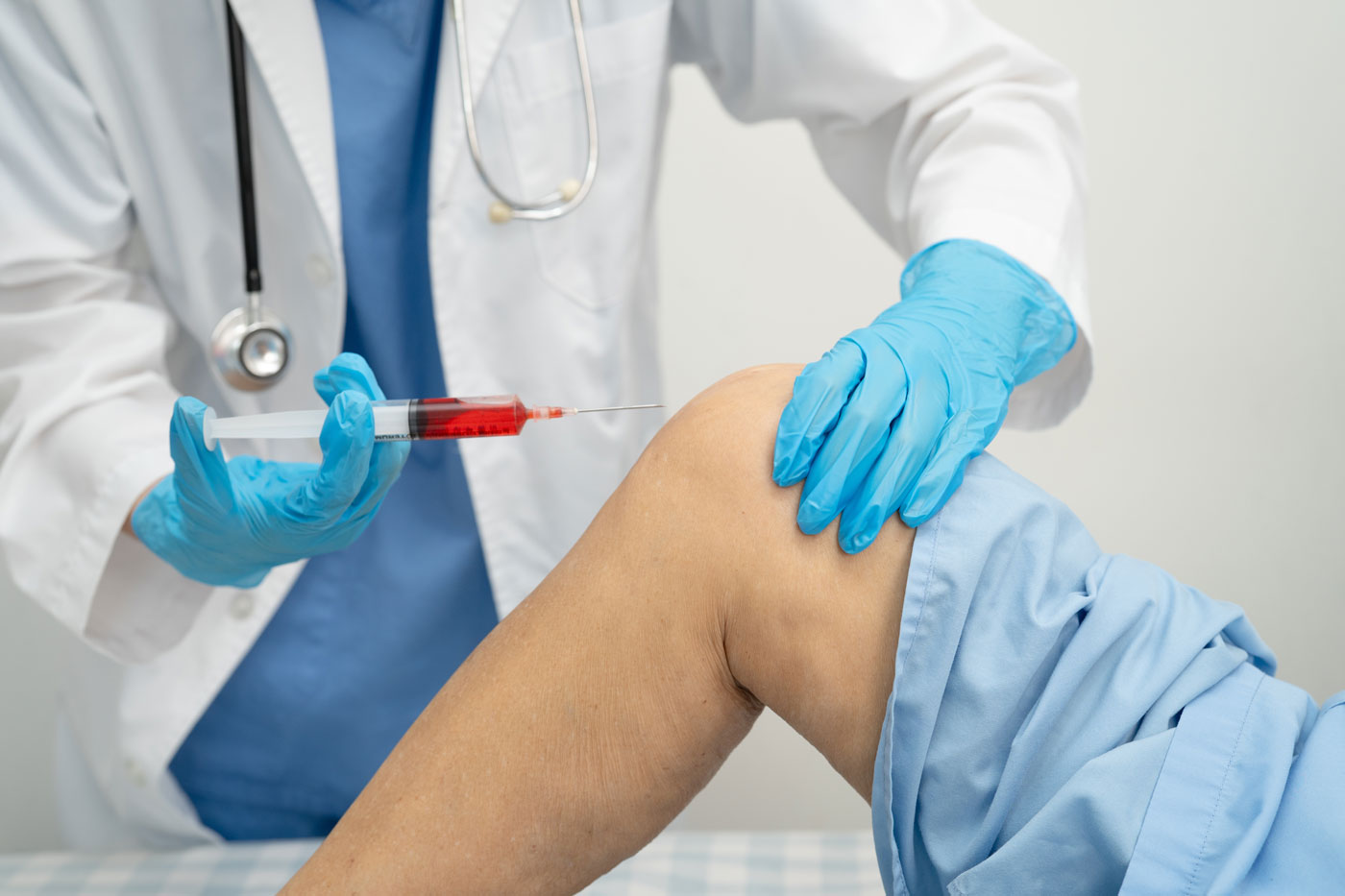 Doctor Injecting Patient's Knee 