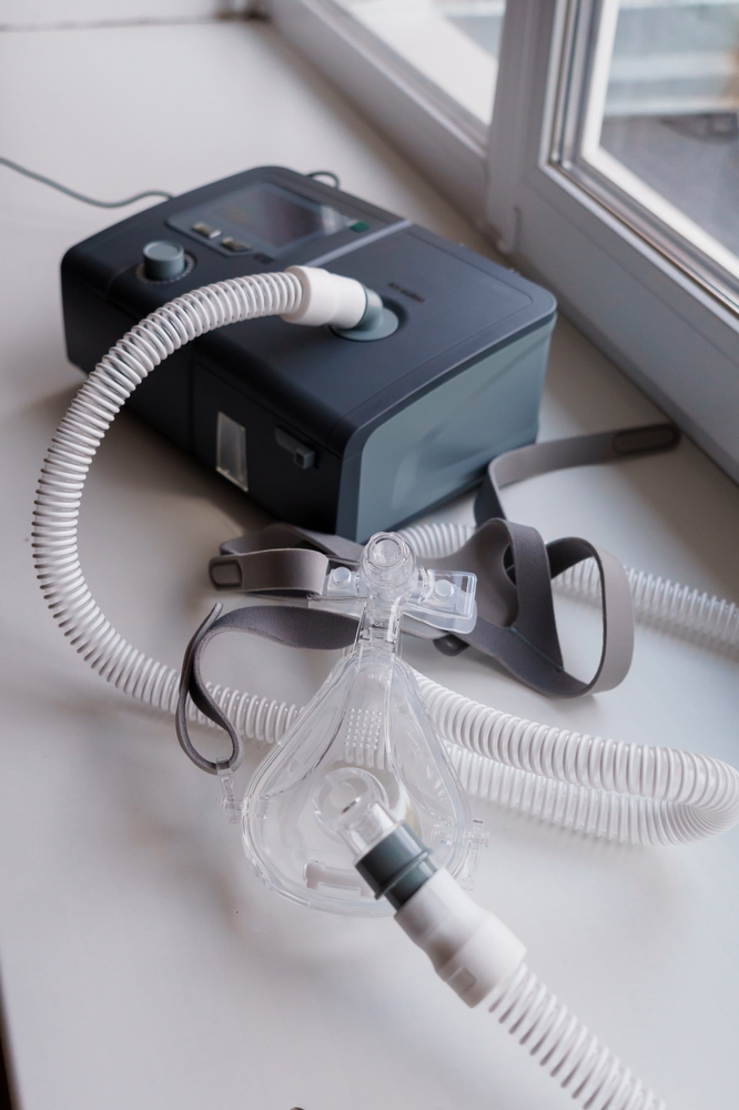 female doctor listening to elderly man's heartbeat