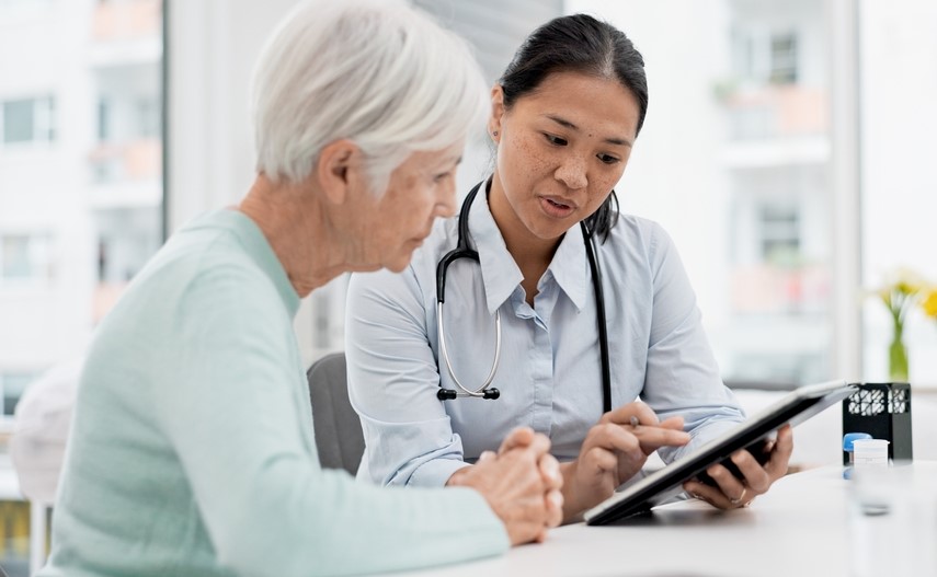 female doctor consulting cardiology chart of patient with nurse