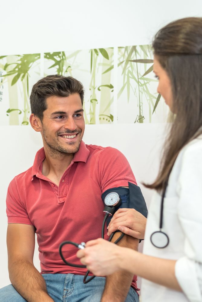 doctor measuring blood pressure of patient