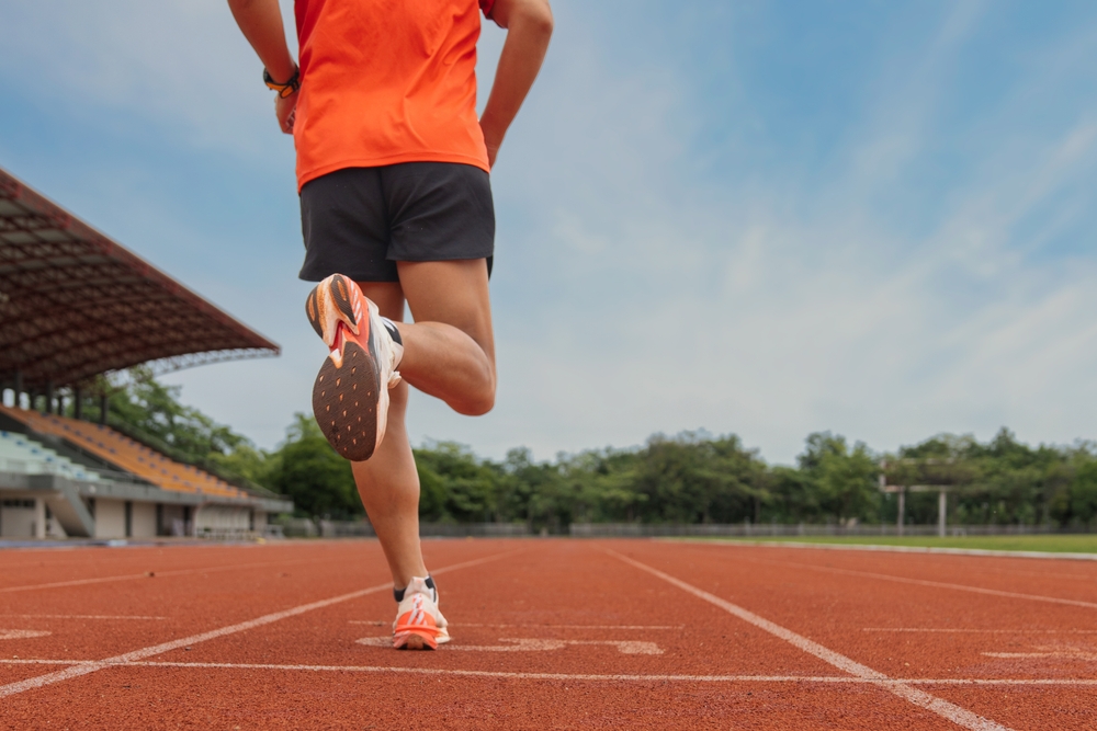 healthy athlete running on track