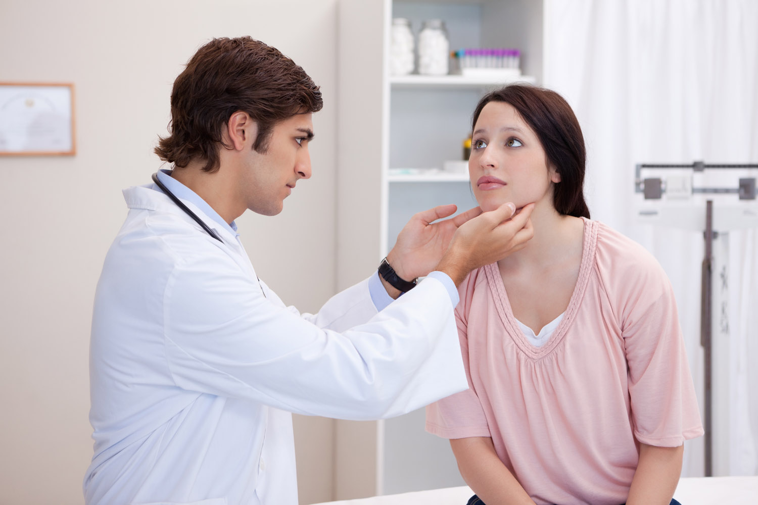 male doctor examining patients jaw
