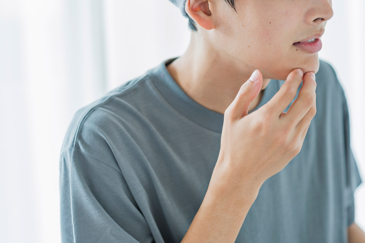 young man touching his jaw