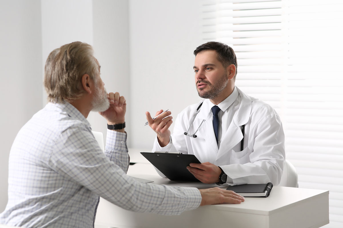 female nurse listening to elderly woman's heartbeat