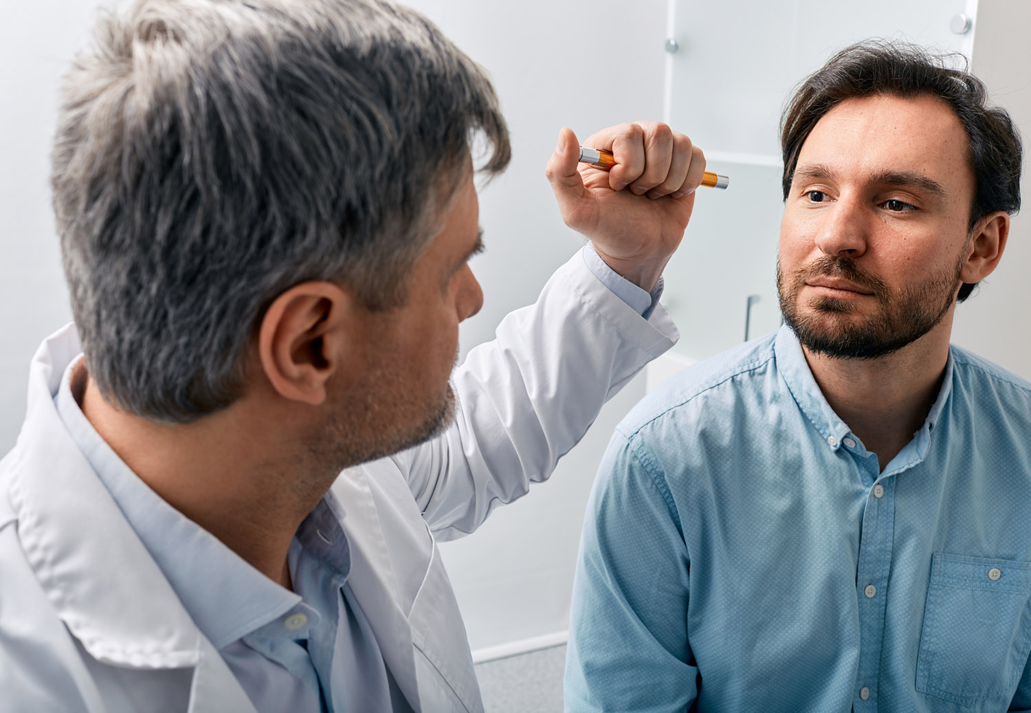 doctor examining patient checking reflexes