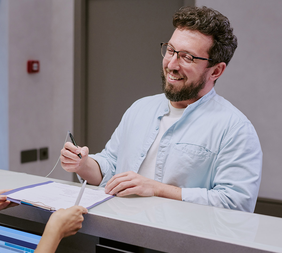 Patient completing intake paperwork at Townsen Physician Group in Houston