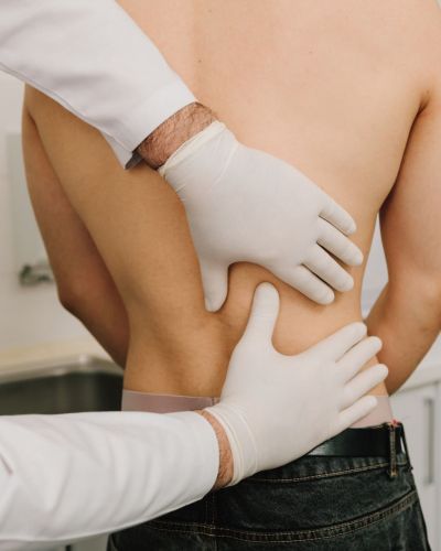 Doctor Hands Checking on Patients Back