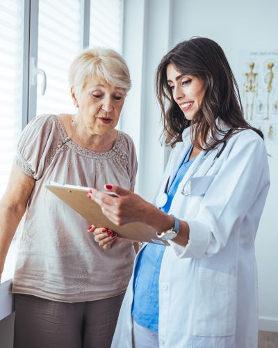 female gynecologist showing an elderly patient her chart