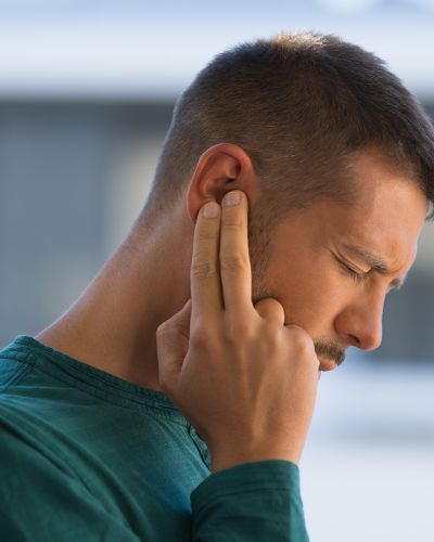 Man Touching Ear
