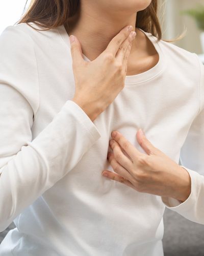 Female Patient Holding Chest 