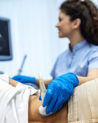 Female Ultrasound Specialist Checking on Patients Kidneys