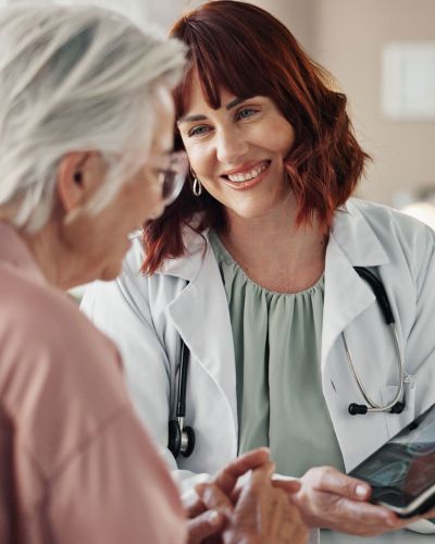 female nurse talking to elderly patient
